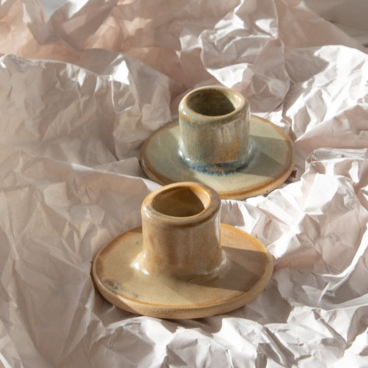 Two handmade ceramic candle holders that fit any standard candle